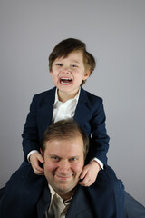 father and son piggy back ride