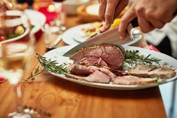One slice is never enough. Cropped shot of roast beef on a dining table.