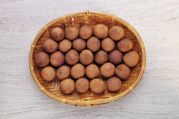 Dried longans on wooden table 