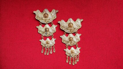 Gold brooch, kebaya brooch, isolated on red background