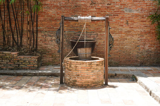 an vintage red brick water well in the courtyard