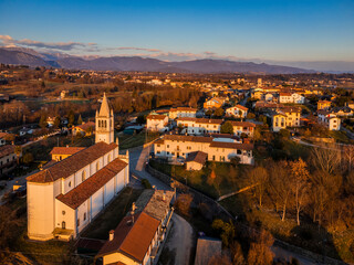 Fototapeta na wymiar Sunset on the ancient bell tower. Friuli to discover. Conoglano di Cassacco