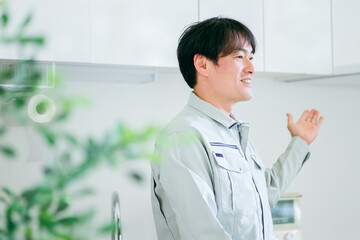 キッチンと作業着姿の男性
