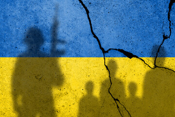 Flag of Ukraine painted on a concrete wall with ukrainian civilians and a russian soldiers shadows. Russian military aggression