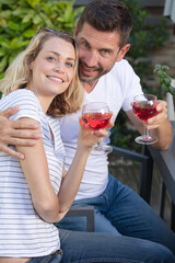smiling couple enjoying a cup of wine