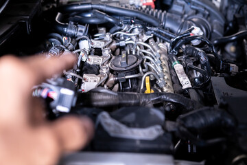 Plakat Engine car service mechanic maintenance inspection service maintenance car Check engine oil level car in garage showroom dealership blurred background.