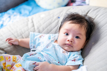 Asian newborn baby kid eye contact with mom cuteness of children with happy family on soft mattress metaphor living life healthy lifestyle cute of kid baby products health products for mother and baby