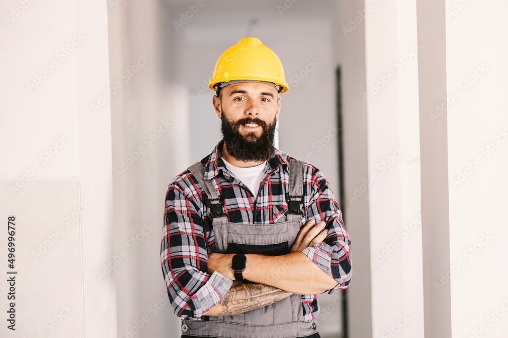 Wall mural a proud worker at his workplace, unfinished building.