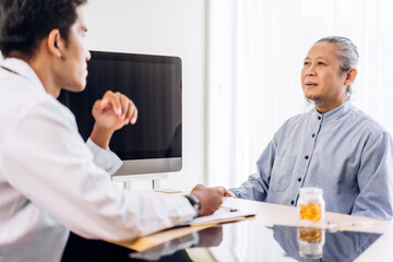 Obraz premium Asian man doctor service help support discussing and consulting talk to asian sick senior man patient at meeting health medical care trust concept in hospital.healthcare and medicine