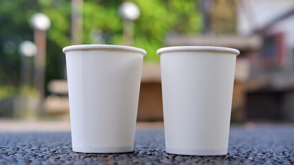 White disposable paper cups, compostable paper cups with blurred background 