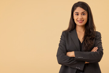 Portrait of a young businesswoman looking at the camera with arms crossed