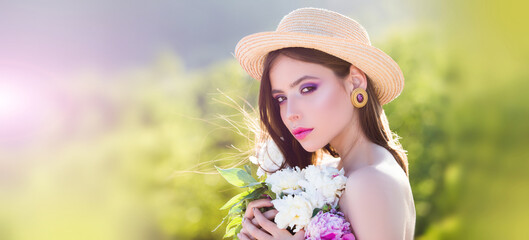 Fototapeta premium Natural beauty face. Beautiful romantic young woman in spring flowers posing on a blossom background. Inspiration of spring and summer. Banner for header website design, copy space.