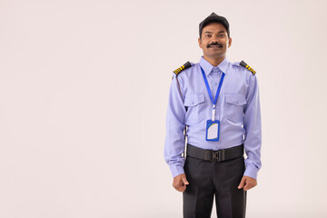 Portrait of male security guard standing in uniform