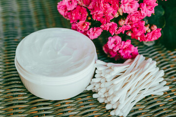 cosmetic cream and flowers