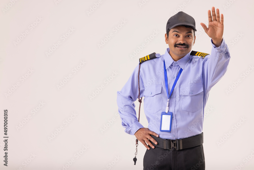 Wall mural Portrait of Security guard gesturing with his palm