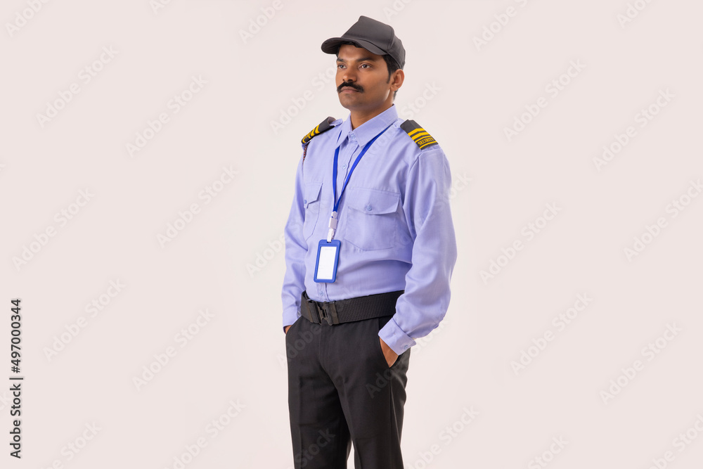 Wall mural portrait of security guard looking elsewhere with hands in pockets