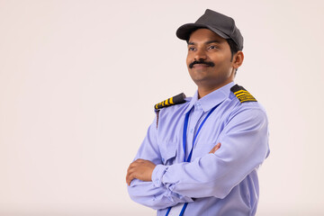 Portrait of Security guard looking elsewhere with arms folded