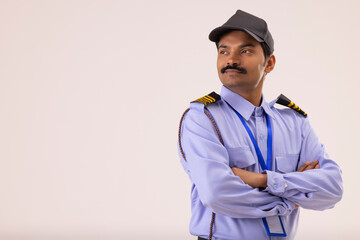 Portrait of Security guard looking elsewhere with arms folded