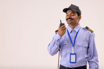 Portrait of Security guard talking over walkie talkie