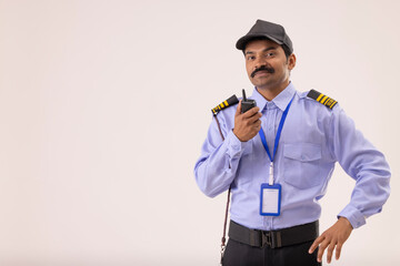 Portrait of Security guard talking over walkie talkie