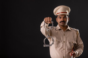 Portrait of an Indian policeman with handcuffs