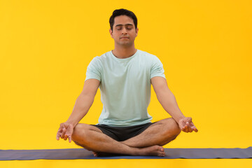 Portrait of a young man meditating at home