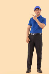 Portrait of a courier delivery boy pointing elsewhere with finger