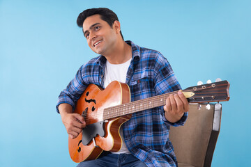 Portrait of a young musician playing guitar
