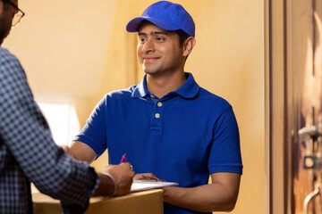 Customer signing the receipt after receiving his parcel from the delivery boy