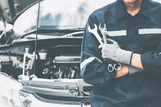 Hand of car mechanic with wrench. Auto repair garage. mechanic w