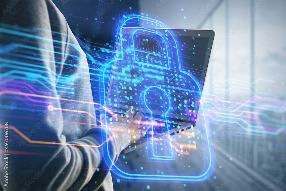 Poster hacker using laptop with creative glowing digital padlock hologram on blurry office interior backgro