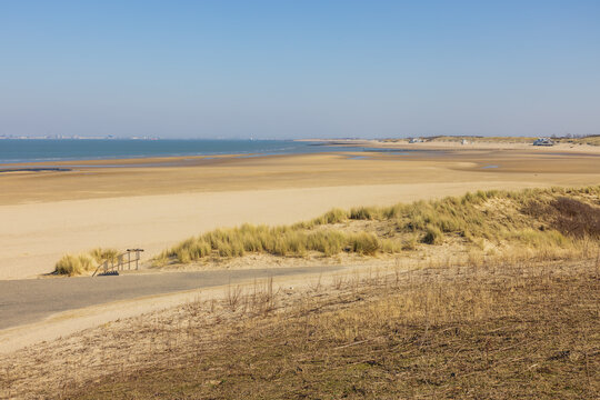 The mouth of the Scheldt with sandy beaches and with  the contours of Vlissingen in a far distance