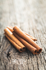 Dry cinnamon sticks on wooden table. Cinnamon spice.