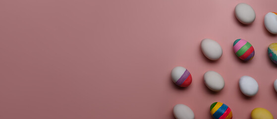 Easter holiday, Festive composition. Colorful Easter eggs on pink background with copy space for text or design.