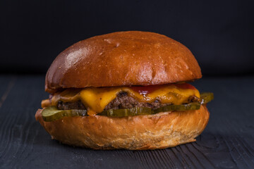 Classic burger. Bun, beef cutlet, cheese, lettuce, tomato, cucumber