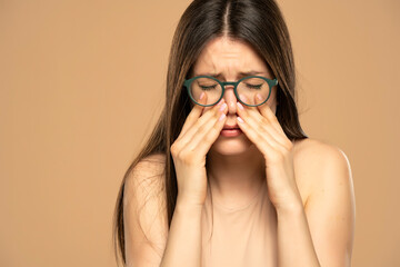 Sinus pain, sinus pressure, sinusitis. Sad woman with glasses, holding her nose because sinus pain...