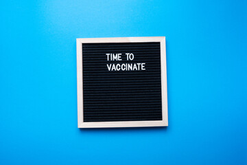Time to vaccinate inscription on a blue background. Vaccination concept.