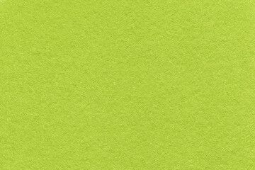 Plakat Texture of bright green and olive colors paper background, macro. Structure of dense lime craft cardboard.