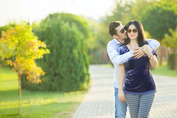 A young married couple walking in the Park.