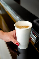 woman holding paper cup of coffee