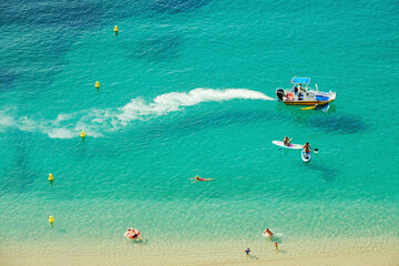 Aerial view of a perfect beach in the French Riviera, with people enjoying the crystalline waters of the mediterranean sea