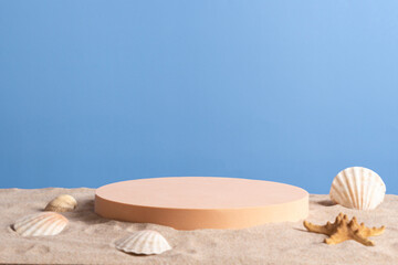 Fototapeta na wymiar Empty round beige platform podium with sea shells and starfish on white beach sand background. Minimal creative composition background for cosmetics or products presentation. Front view