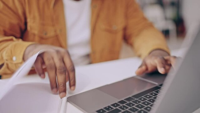 African American man working on laptop form home, freelancing, remote job