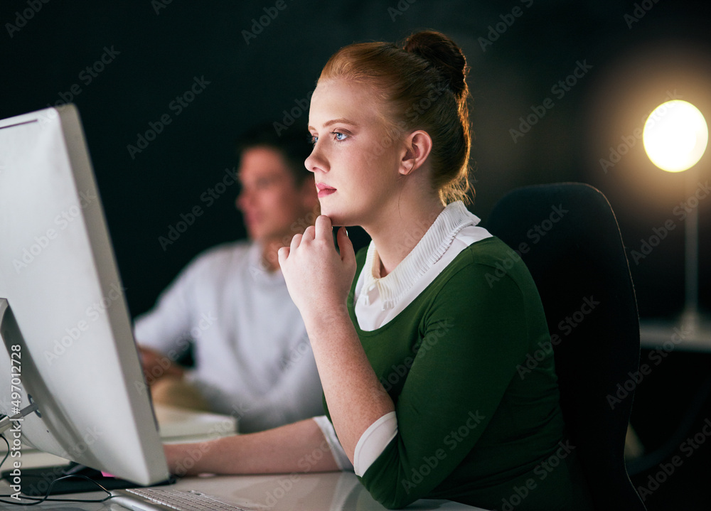 Poster working hard to make the deadline. shot of a young businesswoman working on a computer in an office 