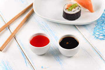Sauce for sushi in white bowl.