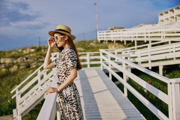 woman with hat sunglasses dresses walk travel summer