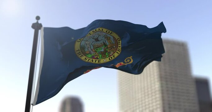 Idaho state waving flag on blurry background, USA state news illustration. Blurry background