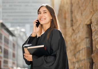 You miss 100 of the shots you dont take. Shot of a young female judge using her smartphone to make...