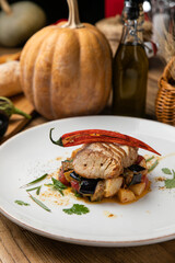 Eggplant dish in a restaurant on a wooden table
