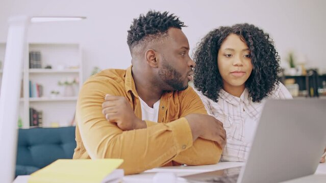 Young black couple choosing school for their child online, discussing options